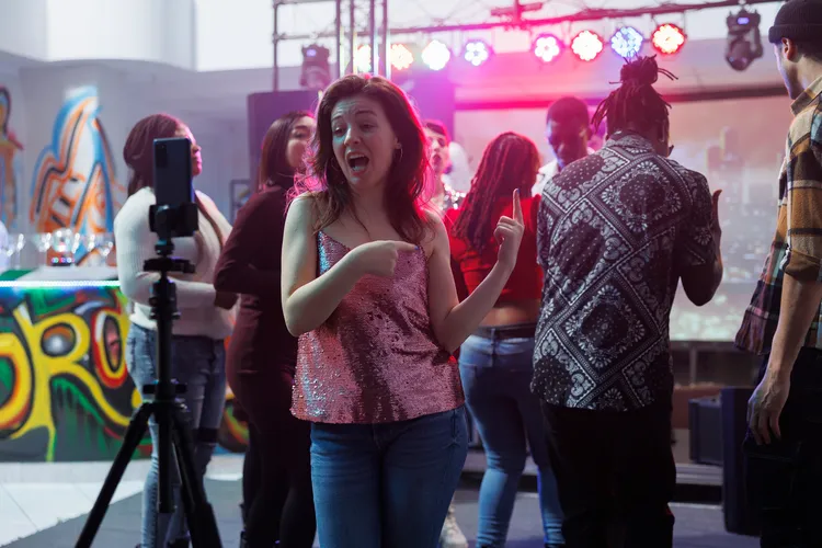 woman recording smartphone video club